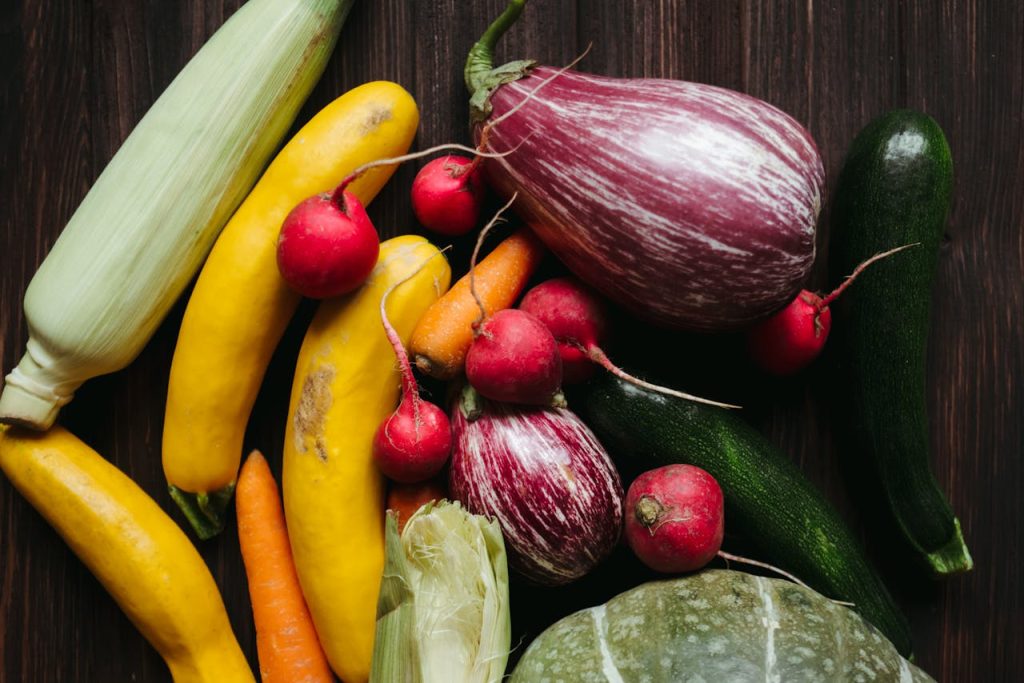 pexels-photo-5644971 A vivid array of fresh vegetables on a dark wooden table, showcasing a healthy, organic lifestyle.